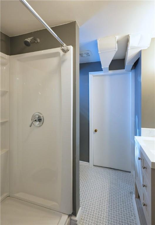 bathroom featuring vanity and walk in shower