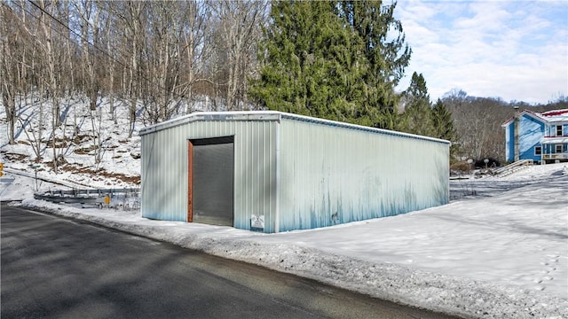 snow covered structure with an outdoor structure