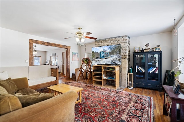 living area with ceiling fan and wood finished floors