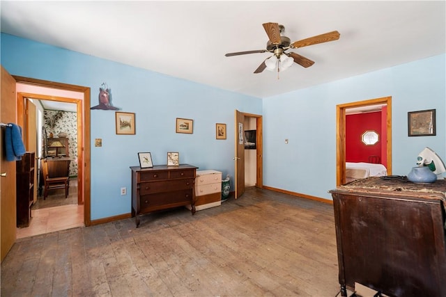 bedroom featuring a ceiling fan, light wood-type flooring, and baseboards