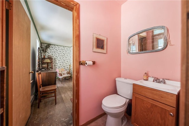 full bath featuring vanity and toilet