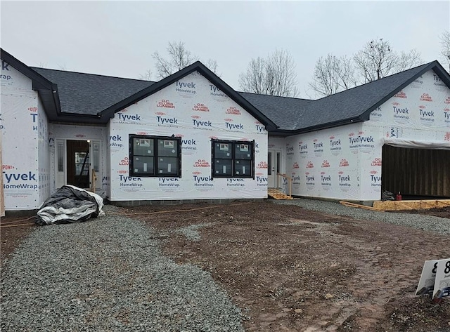 view of front of house featuring roof with shingles