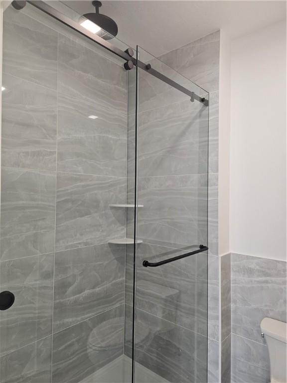 808 10th St, New Stanton, PA 15697 - bathroom with a stall shower and tile walls