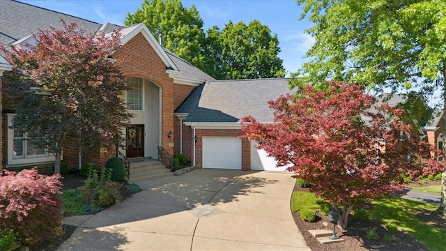 traditional home with brick siding, an attached garage, concrete driveway, and roof with shingles