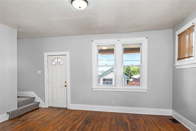 entrance foyer with visible vents, wood-type flooring, baseboards, and stairway