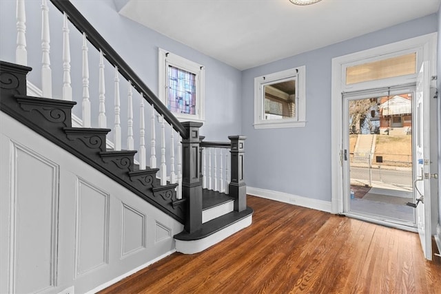 stairway with wood finished floors and baseboards