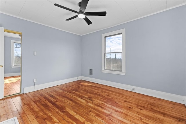 unfurnished room with ceiling fan, wood-type flooring, baseboards, and ornamental molding