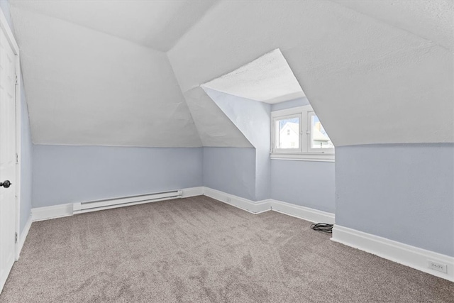 bonus room with carpet flooring, a baseboard heating unit, baseboards, and vaulted ceiling