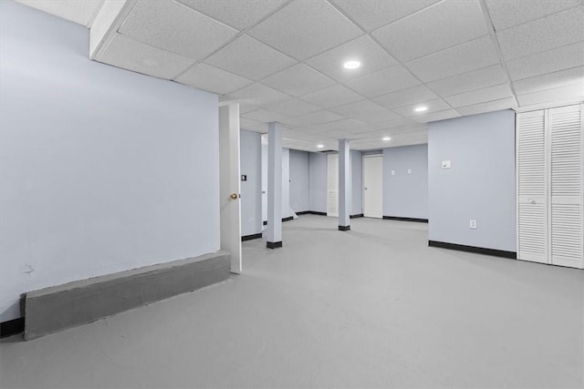 finished basement featuring recessed lighting, a paneled ceiling, and baseboards