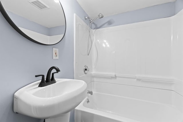 full bath featuring tub / shower combination, visible vents, and a sink