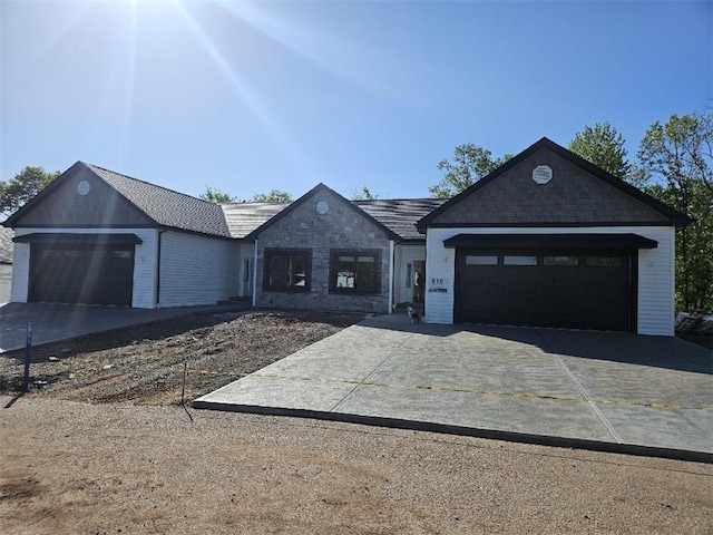 812 10th St, New Stanton, PA 15697 - single story home with an attached garage, concrete driveway, and stone siding
