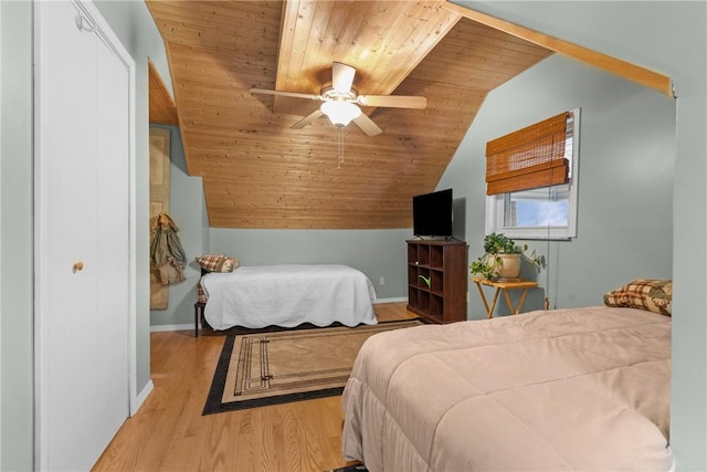 bedroom with lofted ceiling, a ceiling fan, wood finished floors, wooden ceiling, and baseboards