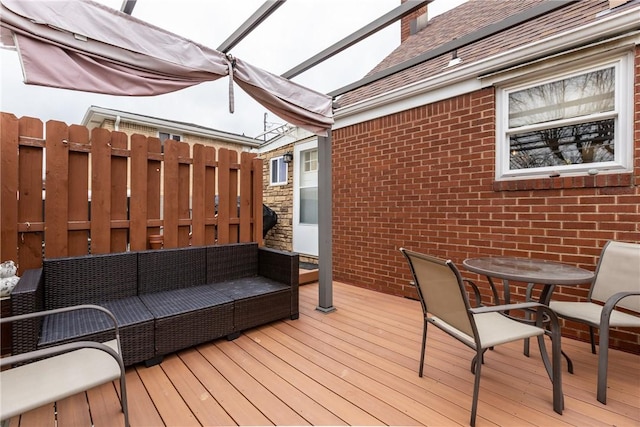 deck featuring an outdoor living space, outdoor dining area, and fence