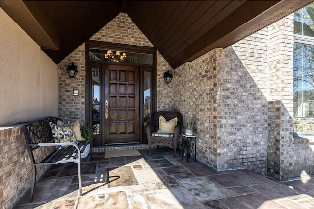 doorway to property with brick siding