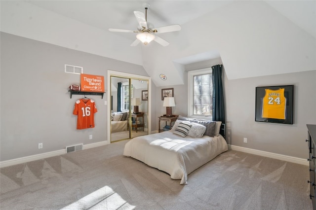 carpeted bedroom featuring a closet, visible vents, baseboards, and vaulted ceiling