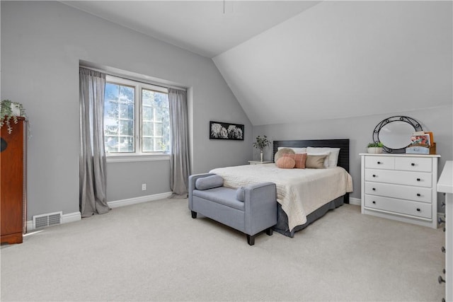 bedroom with vaulted ceiling, baseboards, visible vents, and light carpet