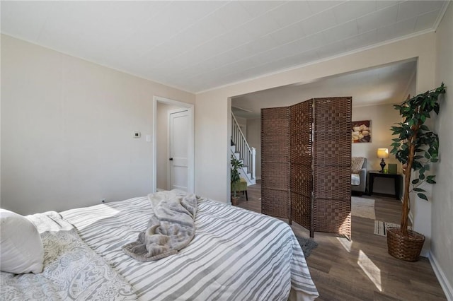 bedroom featuring wood finished floors and baseboards