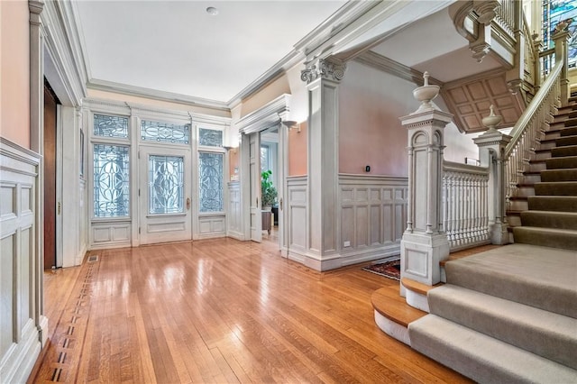 5435 Dunmoyle St, Squirrel Hill, PA 15217 - entryway featuring a decorative wall, crown molding, light wood-style floors, stairway, and wainscoting