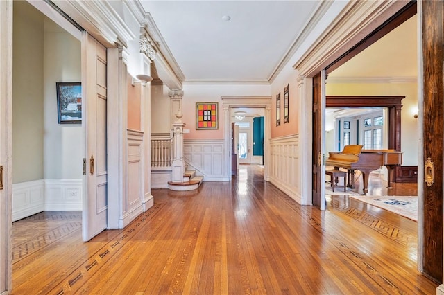 5435 Dunmoyle St, Squirrel Hill, PA 15217 - hall featuring a decorative wall, a wainscoted wall, light wood-style floors, ornamental molding, and stairs