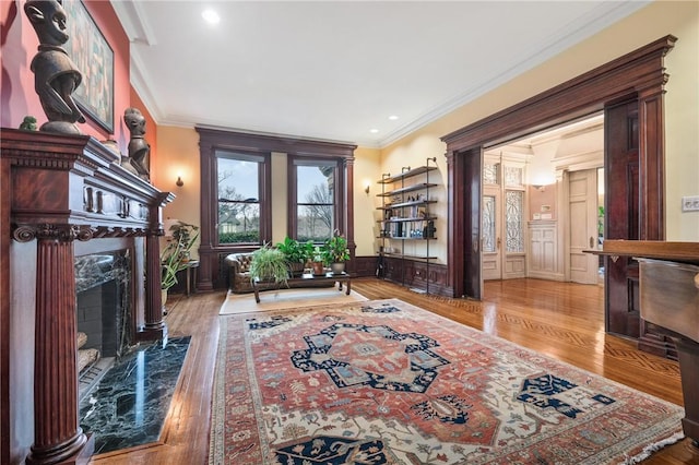 5435 Dunmoyle St, Squirrel Hill, PA 15217 - living area featuring a premium fireplace, ornamental molding, wood finished floors, and recessed lighting