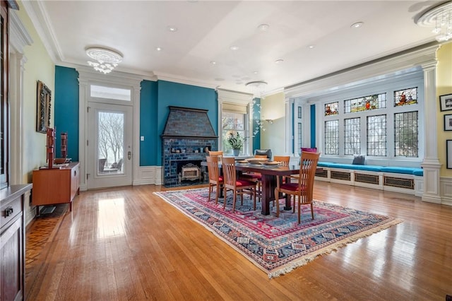 5435 Dunmoyle St, Squirrel Hill, PA 15217 - dining space featuring ornamental molding, plenty of natural light, wood finished floors, a fireplace with flush hearth, and a wainscoted wall