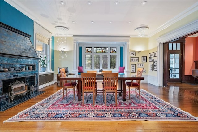5435 Dunmoyle St, Squirrel Hill, PA 15217 - dining area featuring crown molding, plenty of natural light, a fireplace, wood finished floors, and a wainscoted wall