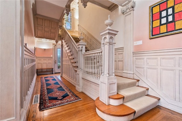 5435 Dunmoyle St, Squirrel Hill, PA 15217 - stairs with a decorative wall, wood finished floors, ornamental molding, wainscoting, and decorative columns