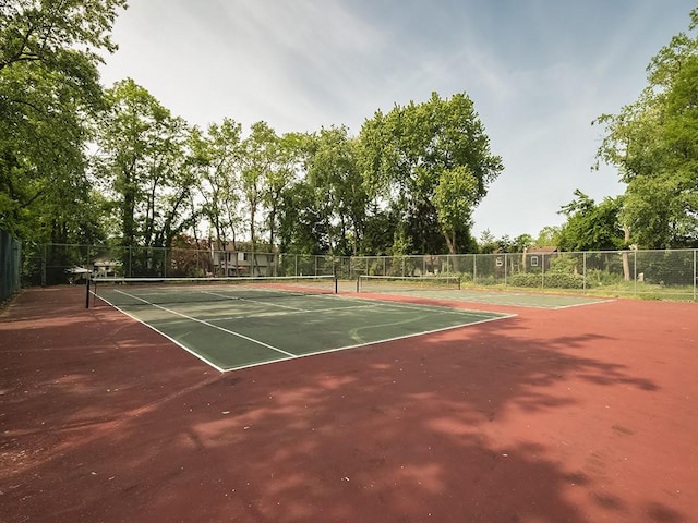 view of tennis court featuring fence