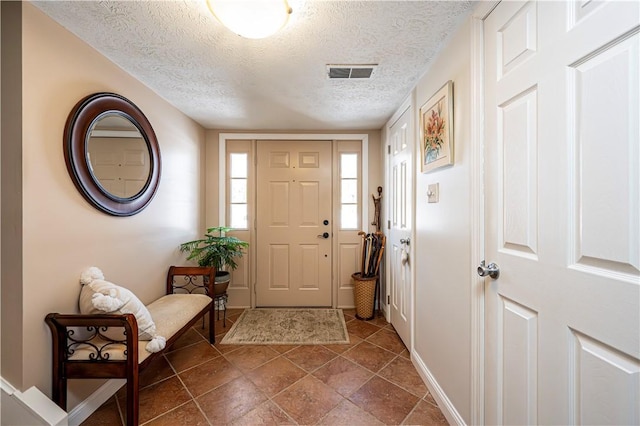 entrance foyer with visible vents and a textured ceiling