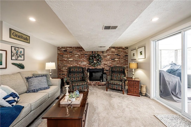 living area with recessed lighting, visible vents, carpet, and a textured ceiling