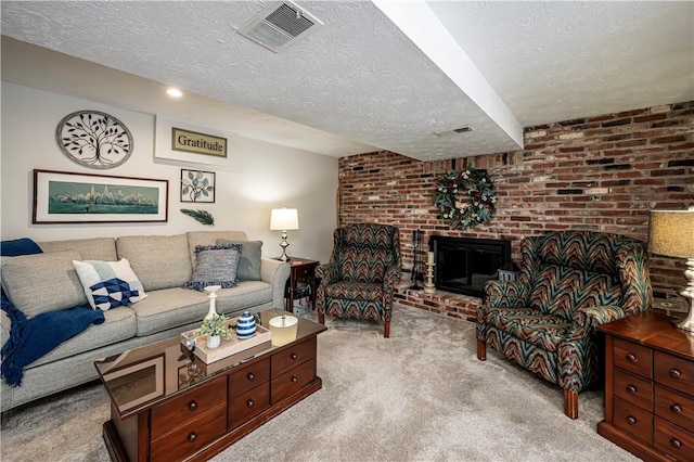 carpeted living area with visible vents, a fireplace, a textured ceiling, and brick wall