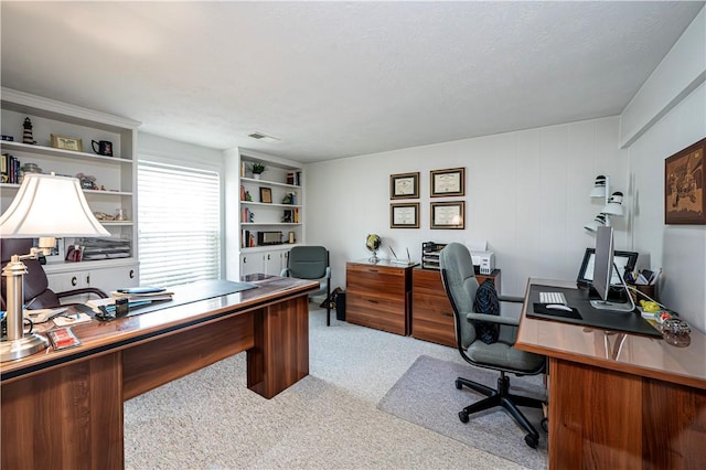 office space with a textured ceiling and carpet