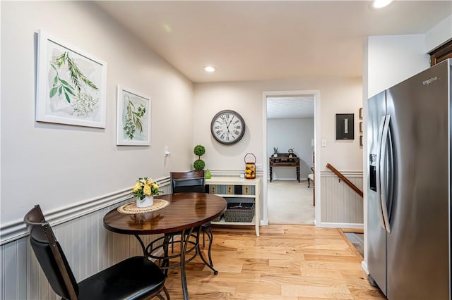 dining area featuring a wainscoted wall, recessed lighting, and light wood-type flooring