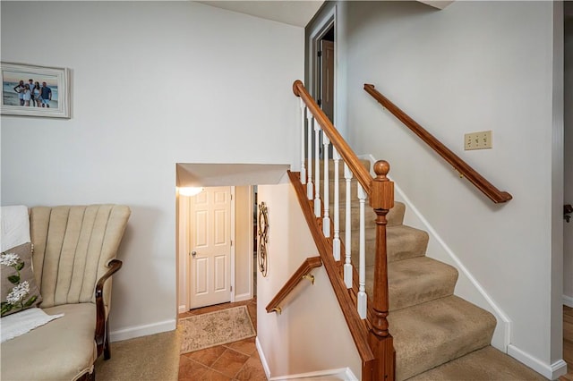 staircase featuring baseboards