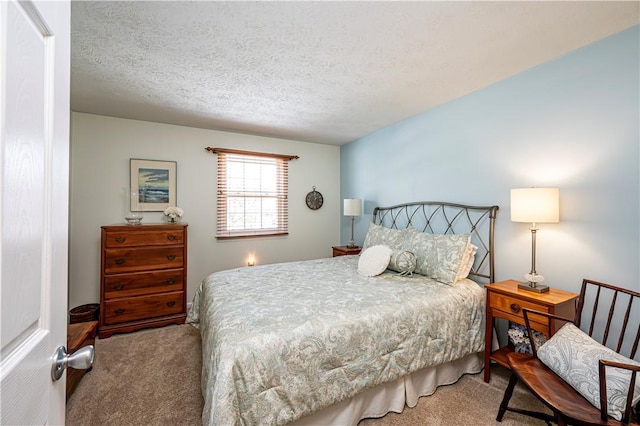 bedroom featuring a textured ceiling and carpet floors