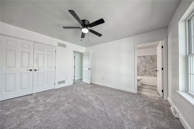 unfurnished bedroom with visible vents, baseboards, and carpet