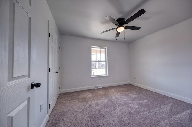 unfurnished bedroom with a ceiling fan, carpet flooring, visible vents, and baseboards