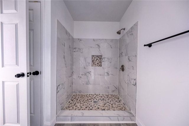 bathroom with tiled shower