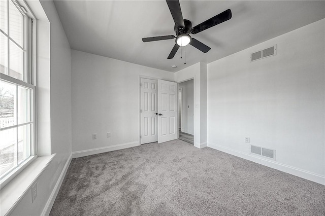 unfurnished bedroom with baseboards, visible vents, and carpet floors