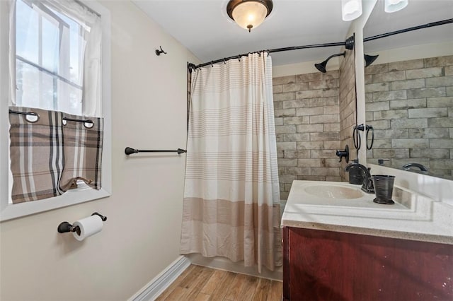 full bathroom featuring vanity, shower / bath combination with curtain, wood finished floors, and baseboards