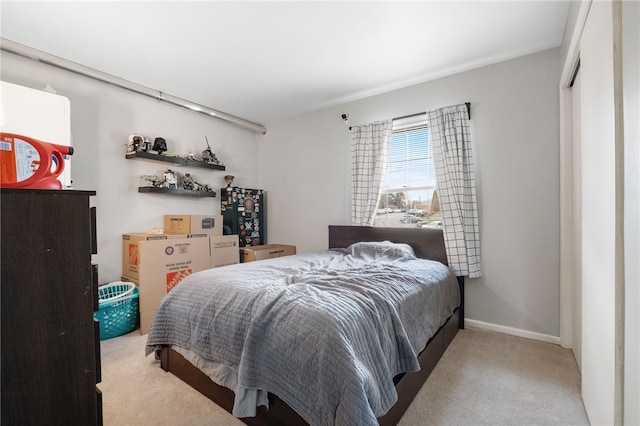 carpeted bedroom featuring baseboards