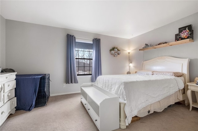 bedroom with light colored carpet and baseboards