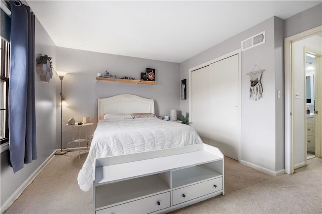 carpeted bedroom with visible vents, baseboards, and a closet