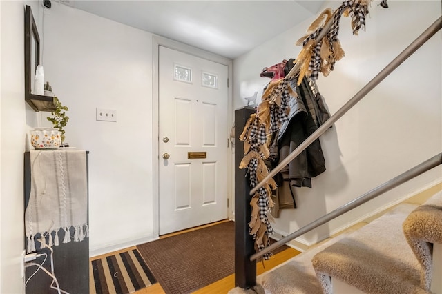 entrance foyer with stairway and wood finished floors