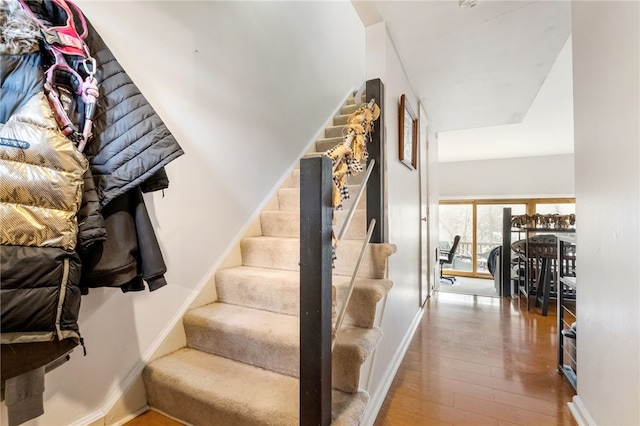 stairs with baseboards and wood finished floors