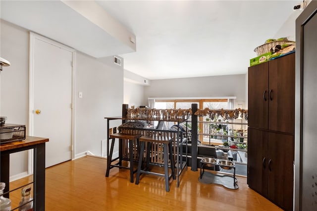 dining room with wood finished floors and visible vents