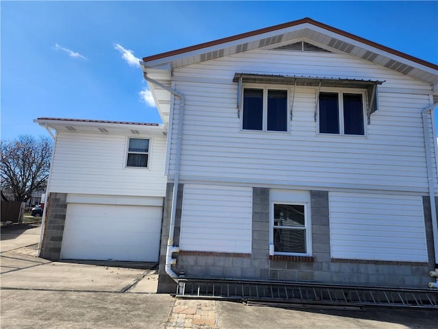 view of front of property featuring concrete driveway and a garage