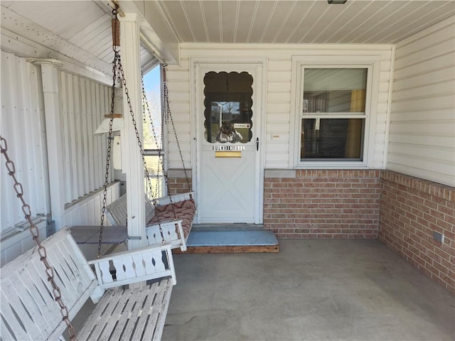 property entrance with brick siding