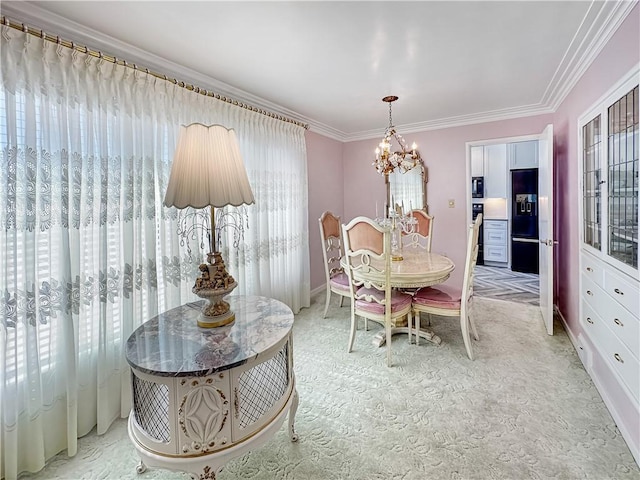 dining area featuring light carpet, a chandelier, and ornamental molding