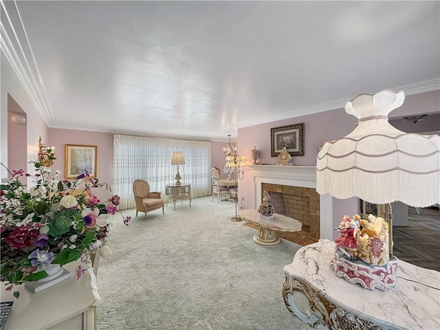 living area with a fireplace, crown molding, carpet, and a chandelier